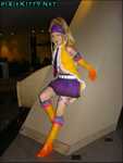 Songstress Rikky against a weird pillar thing.